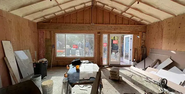Interior of an ADU under construction with vaulted framing