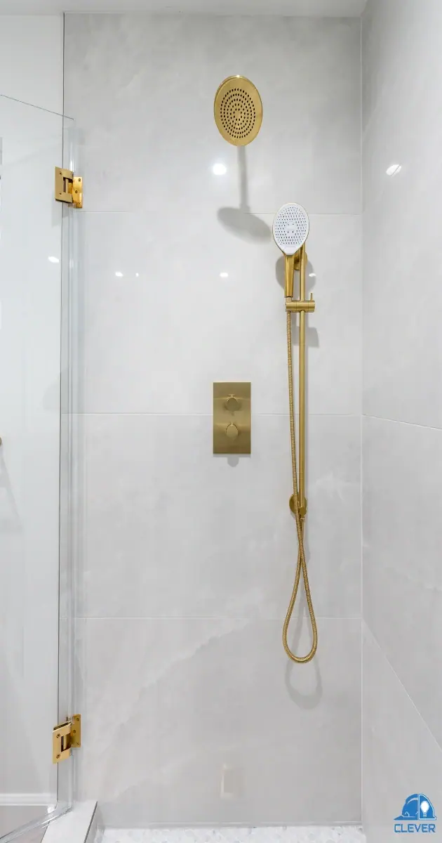 Walk-in shower with brushed-gold fixtures