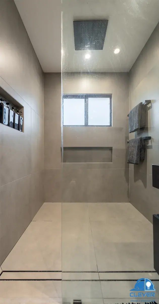 Walk-in shower with a linear drain and rainfall head