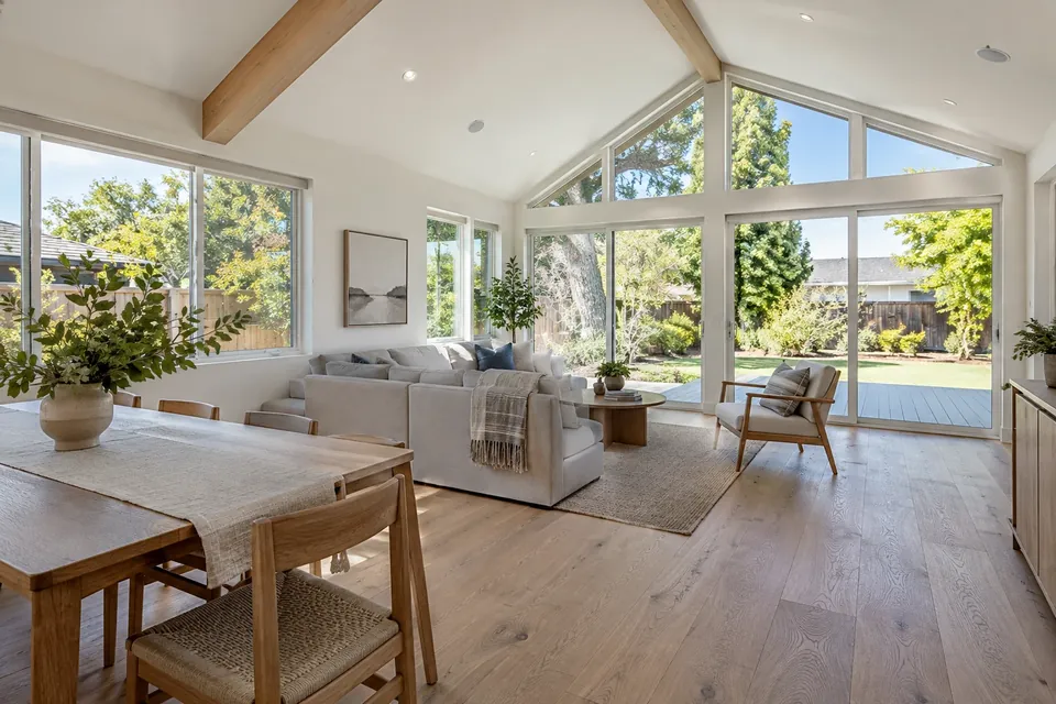 Inside a finished addition in a Mountain View home: vaulted ceiling, big windows to the yard, white-oak floors, simple furniture