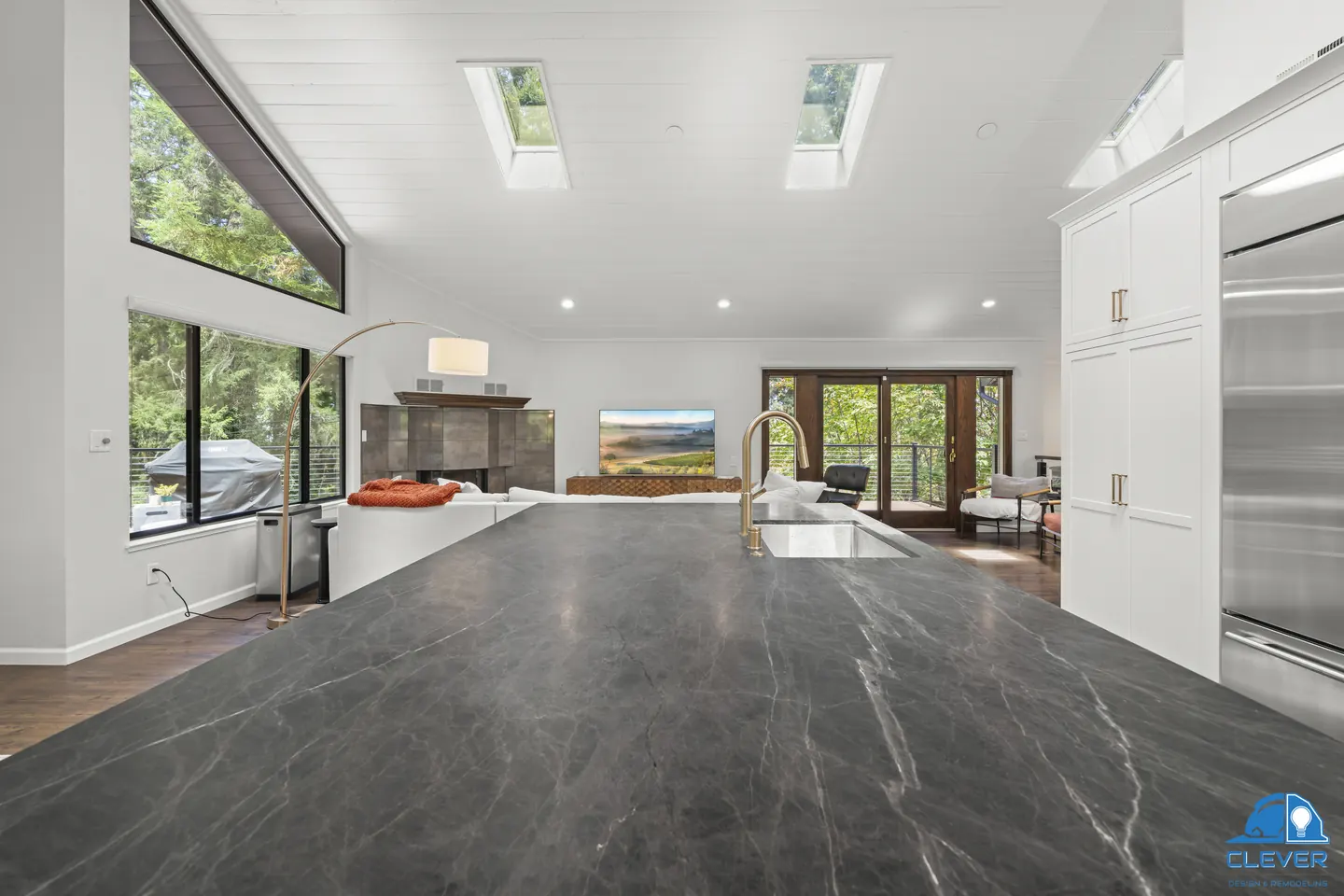 Dark veined stone island top looking out to the living room and deck, kitchen and bath remodel in Los Gatos, CA