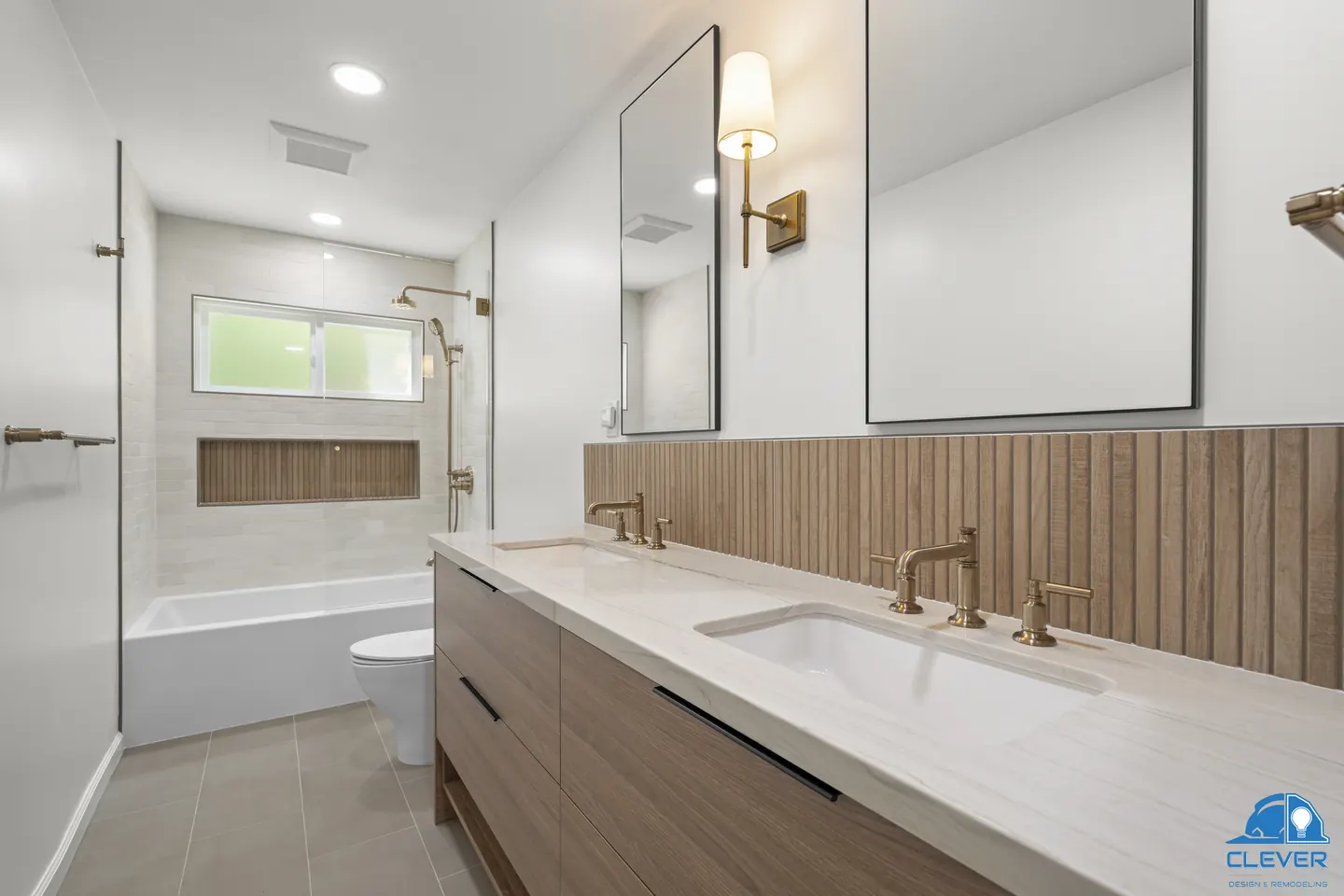 Bathroom with a floating walnut double vanity, fluted wood-look tile and brass faucets and sconces, kitchen and bath remodel in Los Gatos, CA