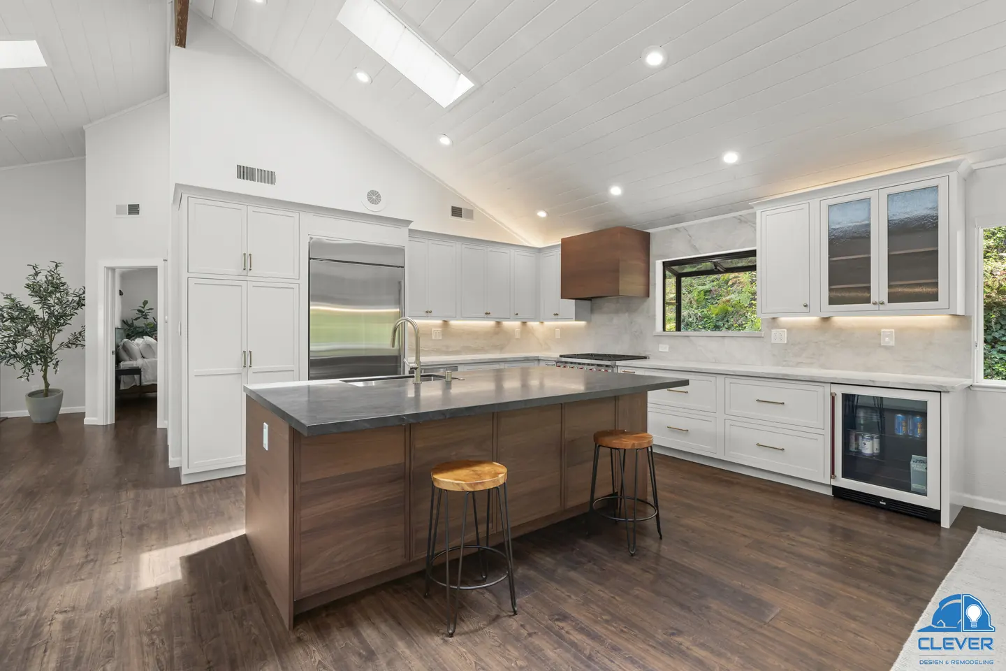 Kitchen with a walnut island and stools, a wine fridge and glass-front upper cabinets, kitchen and bath remodel in Redwood City, CA