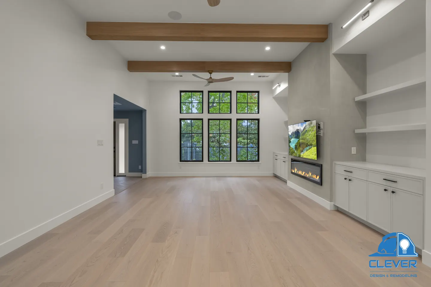 Living room with oak ceiling beams, a linear fireplace and built-in shelves and cabinets, whole-home remodel in Palo Alto, CA
