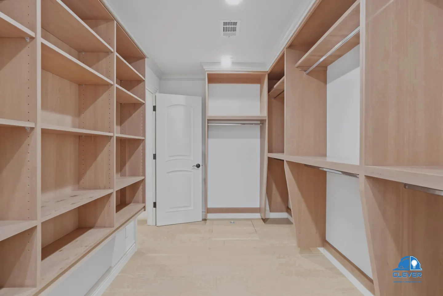 Walk-in closet lined with built-in wood shelving and hanging rods, whole-home remodel in Saratoga, CA